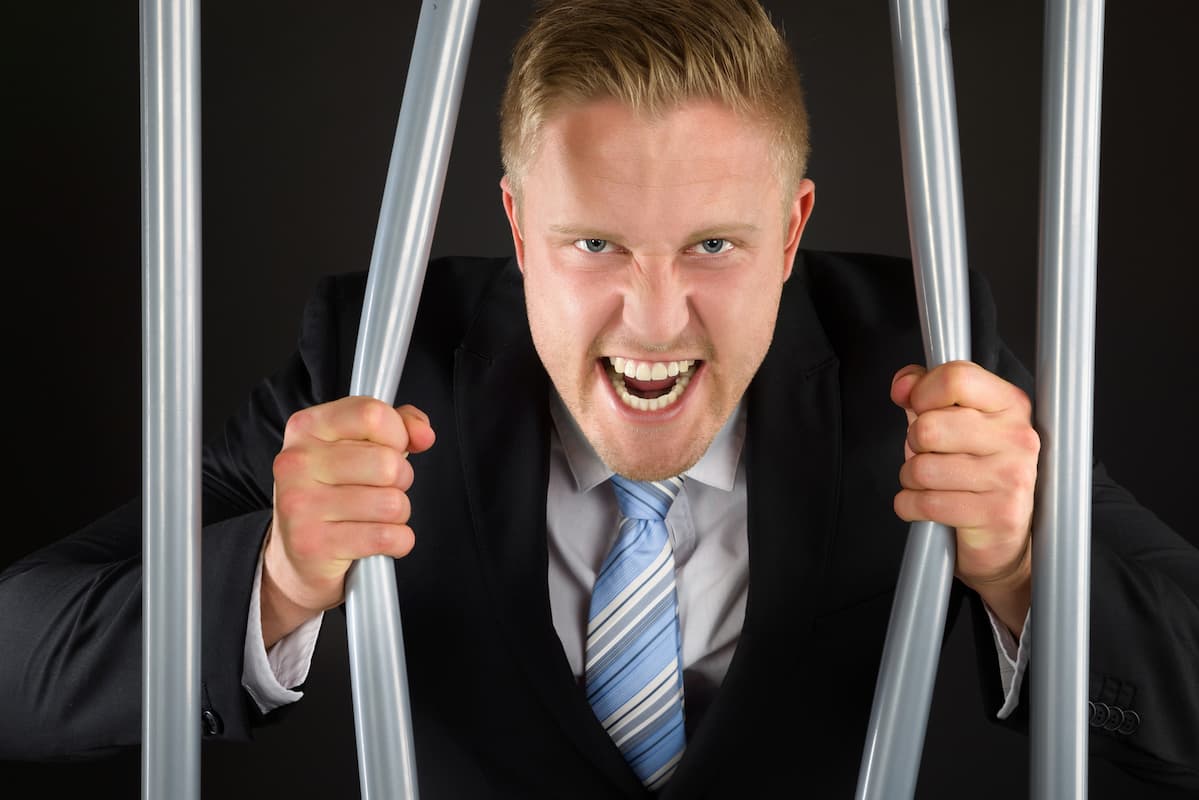 Angry father bending metal bars showing his strength