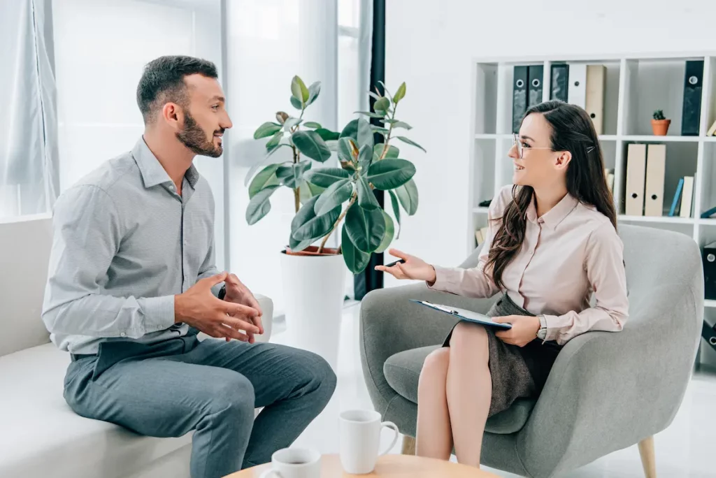 Man who is dating a therapist is sitting in therapy across from a therapist