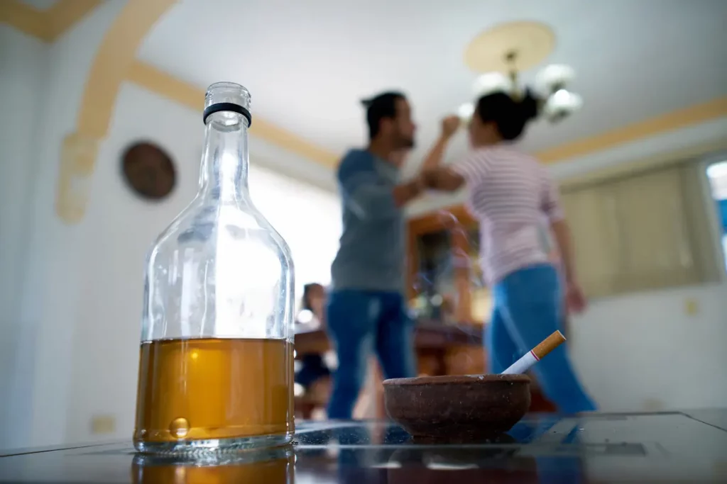 Husband who has been drinking picks fight with his wife in the background