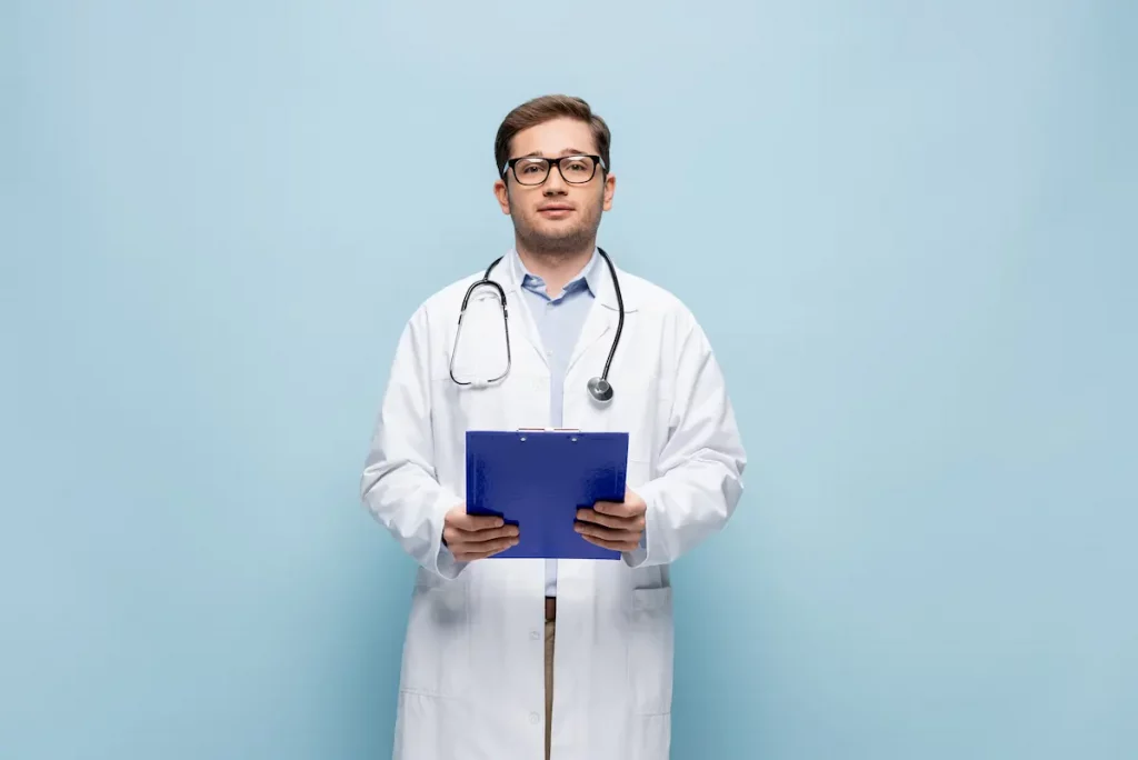 Doctor in white coat holding clipboard preparing for a vasectomy procedure 