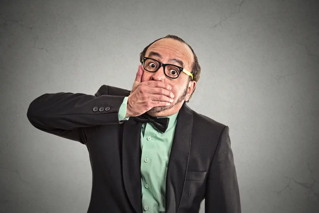 Dad putting hand over his mouth to show how to shut up when talking too much