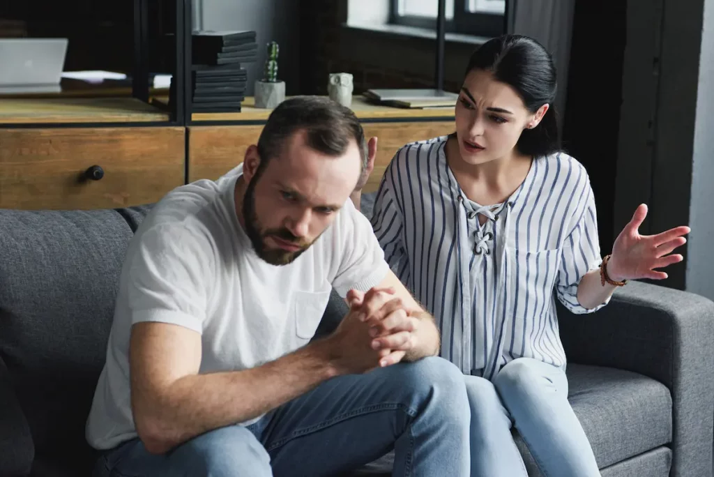 Wife yelling at husband on couch because he got another woman pregnant