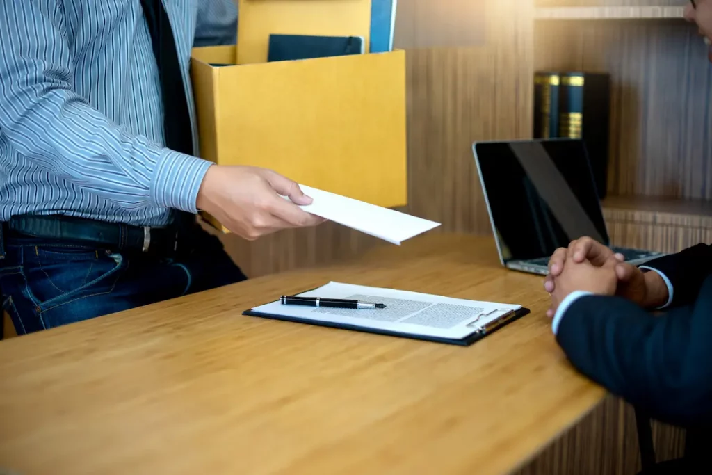 Man handing in his resignation letter to boss and quit his job without telling his wife