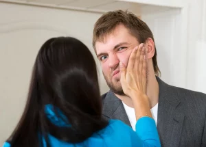 Picture of wife hitting husband in face by slapping him