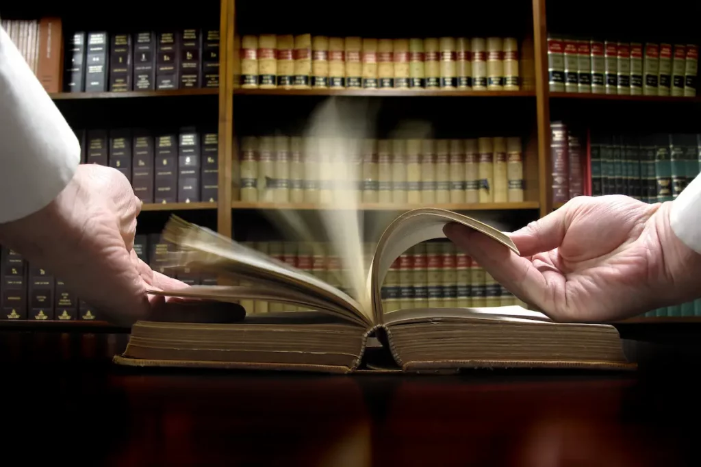 Hands flipping through law book to find answer about divorce 
quickly