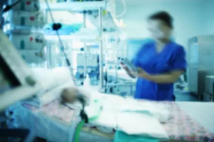 woman in a coma being examined by nurse, blurry