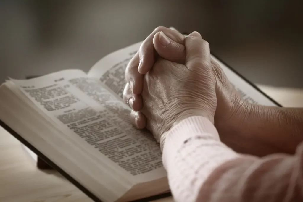 woman with hands on bible reading about divorce