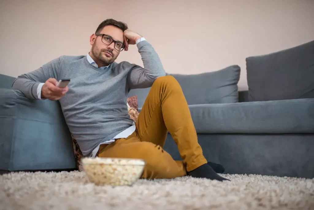 single man watching tv by himself