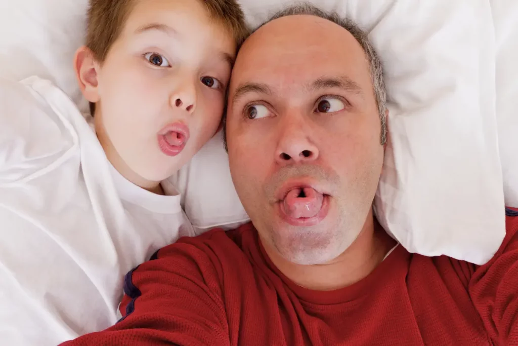 father and son showing family trait of rolling tongue