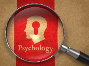 close up of Psychology textbook with magnifying glass over top