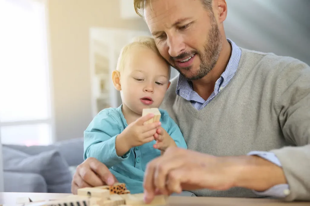 40 year old new father playing with baby son