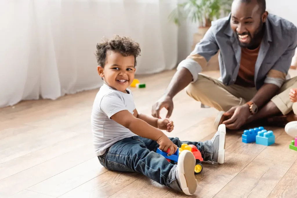 Father and son playing together displaying positive parenting