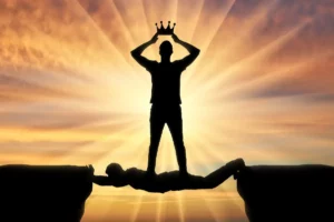 Silhoutte of man using other person as a bridge while holding crown, symbolizing boundaries with narcissistic people