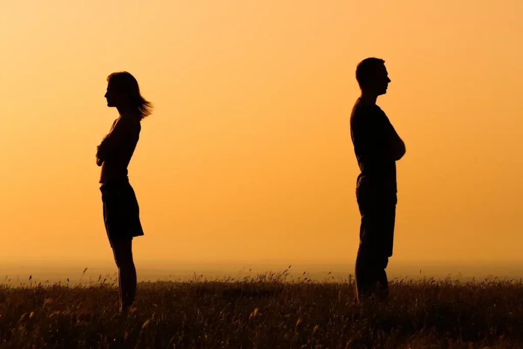 Silhouette of uncooperative ex spouses with backs turned to each other