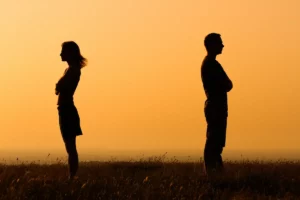 Silhouette of uncooperative ex spouses with backs turned to each other