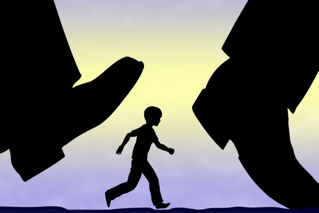 Silhouette of child underneath adults feet symbolizing harmful effects of free-range parenting