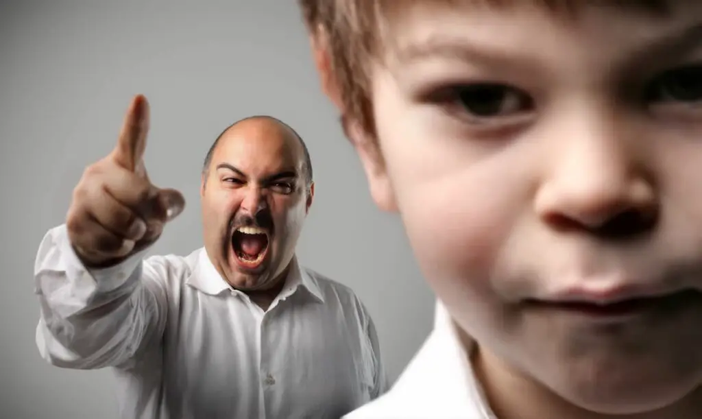 angry and mad father pointing at son while screaming