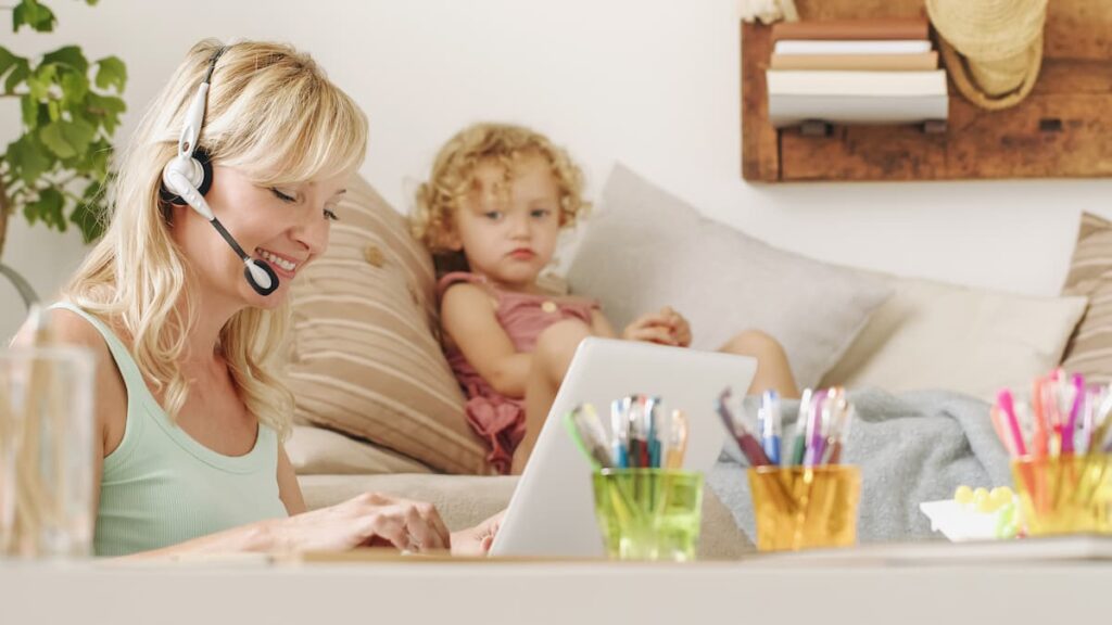 Neglectful mother using computer in front of lonely child