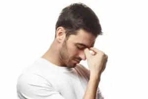 Man holding his eyes while crying