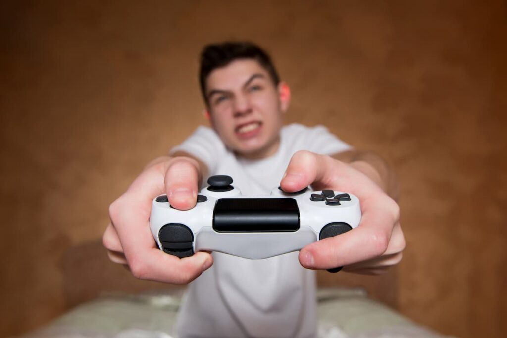 young male addcited to video games close up